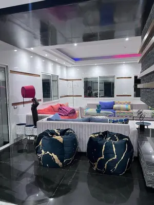 a room with two beds and two chairs at Villa piscine in Temara