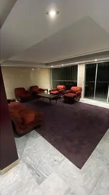 a large room with couches and chairs in a building at Villa piscine in Temara