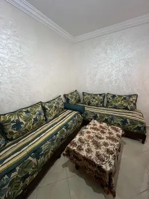 a living room with a couch and a table at Appartement serein & apaisant in Bouznika