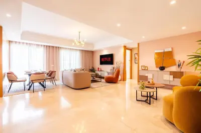 a living room with a couch and a table at Luxury 3 Bedroom Apartment in the Heart of CFC with Swimming pool in Casablanca
