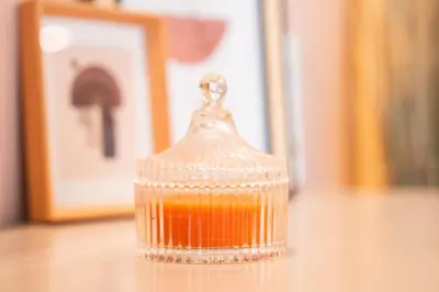 a glass container filled with orange liquid on top of a table at Luxury 3 Bedroom Apartment in the Heart of CFC with Swimming pool in Casablanca