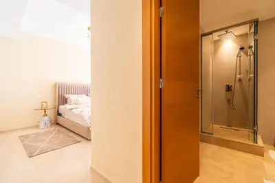 a bathroom with a shower and a bedroom with a bed at Luxury 3 Bedroom Apartment in the Heart of CFC with Swimming pool in Casablanca
