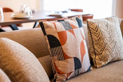two pillows sitting on a couch with a table at Luxury 3 Bedroom Apartment in the Heart of CFC with Swimming pool in Casablanca