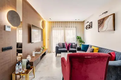 a living room with a couch and a red chair at Awesome place with city view maarif casablanca in Maarif