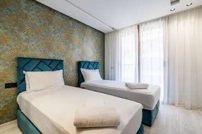 a bedroom with two beds and a wall mural at Les Princesses - 2BR - Balcony - New Residence - Parking - DAR & STAY in Casablanca