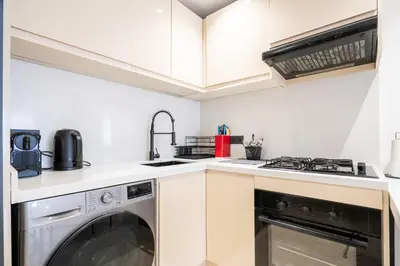 a kitchen with a washer and dryer in it at Les Princesses - 2BR - Balcony - New Residence - Parking - DAR & STAY in Casablanca