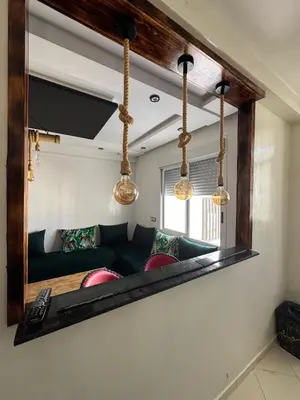 a mirror reflecting a couch in a living room at chambre saada in Dar Bouazza