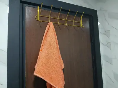 a towel hanging on a towel rack next to a door at chambre saada in Dar Bouazza