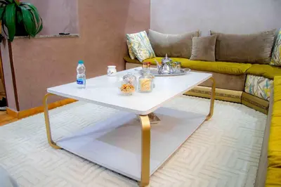 a white coffee table in a living room with a couch at Centre rabat agdal 10min of stade molay aabdellah in Rabat