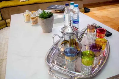 a silver tray with bottles and glasses on a table at Centre rabat agdal 10min of stade molay aabdellah in Rabat