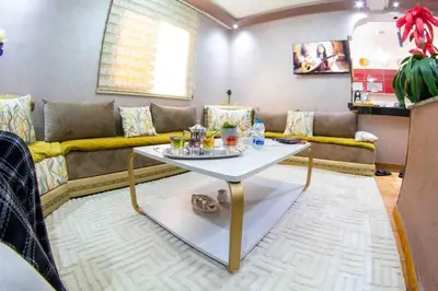 a living room with a couch and a table at Centre rabat agdal 10min of stade molay aabdellah in Rabat