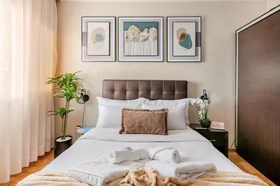 a bedroom with a large bed with towels on it at Centre rabat agdal 10min of stade molay aabdellah in Rabat