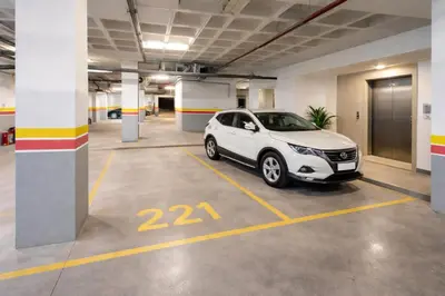 a white car parked in a parking lot at Cozy Apartment Near Airport in Nouaceur