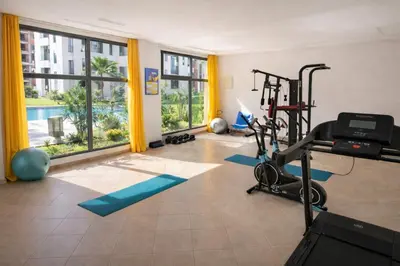 a fitness room with a gym with a treadmill at Cozy Apartment Near Airport in Nouaceur