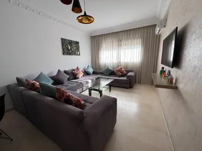 a living room with two couches and a table at Bourgogne Ocean Prestige in Casablanca