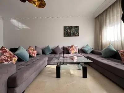 a living room with a couch and a table at Bourgogne Ocean Prestige in Casablanca