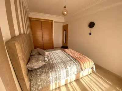 a bedroom with a bed and a couch at Bourgogne Ocean Prestige in Casablanca
