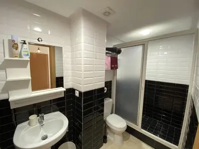 a bathroom with a sink and a toilet at Bourgogne Ocean Prestige in Casablanca