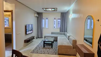 a living room with a couch and a table at Modern and cozy - Central apartment in Casablanca in Casablanca