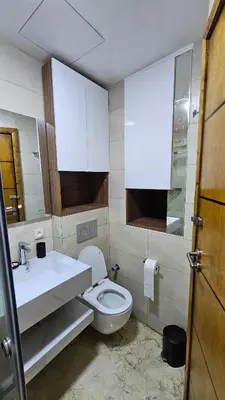 a bathroom with a toilet and a sink and a mirror at Modern and cozy - Central apartment in Casablanca in Casablanca