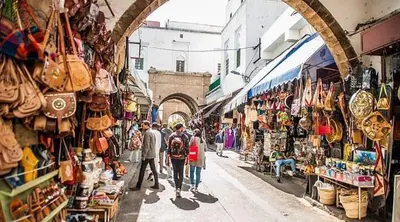a group of people walking down a street in a market at Modern and cozy - Central apartment in Casablanca in Casablanca