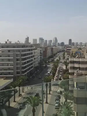 a view of a city street with palm trees and buildings at Luxurious and cozy CFC panoramic view studio in Casablanca