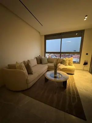 a living room with a couch and a table at Luxurious and cozy CFC panoramic view studio in Casablanca