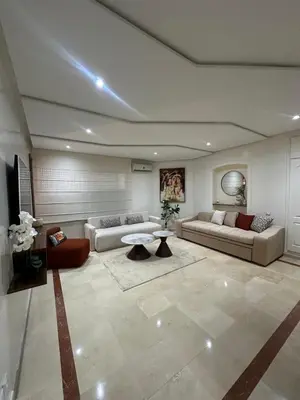 a living room with two couches and a table at Cozy stylish Studio in downtown Casablanca in Casablanca