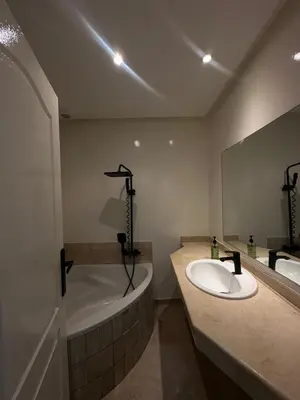 a bathroom with a tub and a sink and a bath tub at Cozy stylish Studio in downtown Casablanca in Casablanca