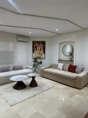 a living room with two couches and a table at Cozy stylish Studio in downtown Casablanca in Casablanca