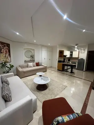 a living room with a couch and a table at Cozy stylish Studio in downtown Casablanca in Casablanca