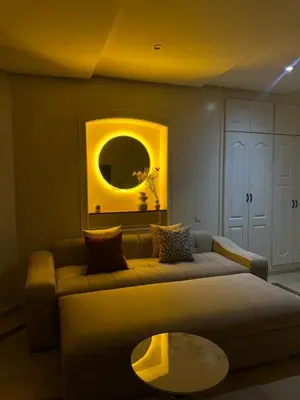 a living room with a couch and a mirror at Cozy stylish Studio in downtown Casablanca in Casablanca