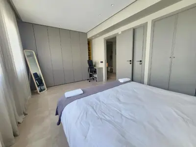 a bedroom with a large white bed in it at The 41 Maarif by IB Signature - Boho Chic 1BR Apt - with Wifi - Self check-in - 24 x7 Security - City View with terrace - Walk to Cafes! City Centre in Casablanca