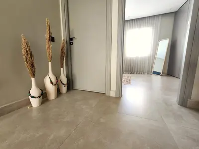 four white vases with plants in them in a hallway at The 41 Maarif by IB Signature - Boho Chic 1BR Apt - with Wifi - Self check-in - 24 x7 Security - City View with terrace - Walk to Cafes! City Centre in Casablanca