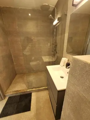 a bathroom with a shower and a sink at The 41 Maarif by IB Signature - Boho Chic 1BR Apt - with Wifi - Self check-in - 24 x7 Security - City View with terrace - Walk to Cafes! City Centre in Casablanca
