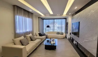 a living room with a couch and a table at Bel Appartement Spacieux et Lumineux Maarif in Casablanca