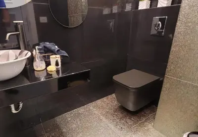 a bathroom with a sink and a toilet and a mirror at Bel Appartement Spacieux et Lumineux Maarif in Casablanca