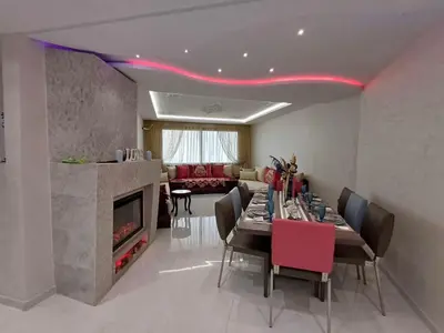 a dining room with a table and a fireplace at Prestigious apartment Elegant and refined in Casablanca