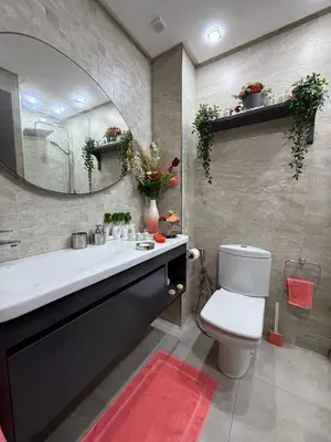 a bathroom with a sink and a toilet and a mirror at Prestigious apartment Elegant and refined in Casablanca