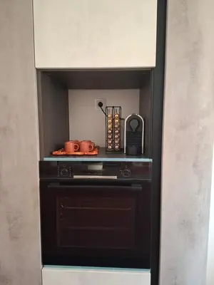 a kitchen with a black stove with pots and pans at Prestigious apartment Elegant and refined in Casablanca