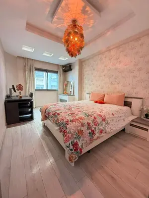 a bedroom with a large bed and a chandelier at Prestigious apartment Elegant and refined in Casablanca