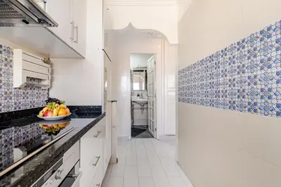 a kitchen with blue and white tiles on the wall at Comfort Pool Apartment Heart of Tamaris in Tamaris