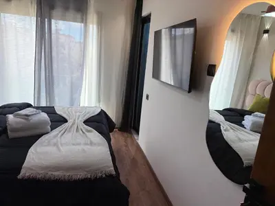 a bedroom with two beds and a mirror on the wall at Studio Le plus Beau Casablanca in Casablanca
