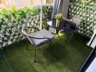 a balcony with two chairs and a table and a plant at Studio Le plus Beau Casablanca in Casablanca