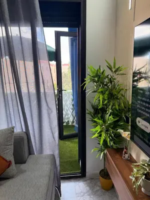 a living room with a couch and potted plants at Studio Best in Casablanca in Casablanca