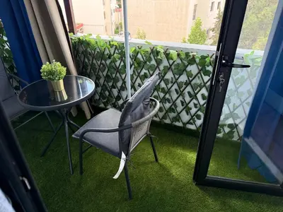 a balcony with a glass table and a chair at Studio Best in Casablanca in Casablanca