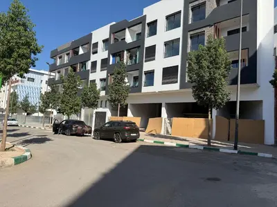 two cars parked in a parking lot in front of a building at Studio Best in Casablanca in Casablanca