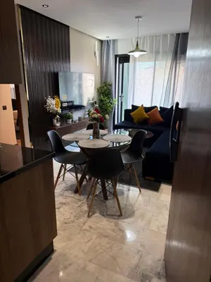 a living room with a table and a couch at Studio Le Cœur Casablanca in Casablanca