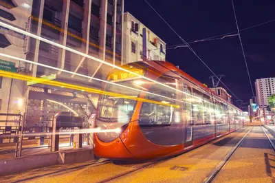 a train on a city street at night at Studio Le Cœur Casablanca in Casablanca