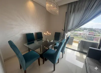 a dining room with a table and blue chairs at Beachside Charming Apartment in Tamaris